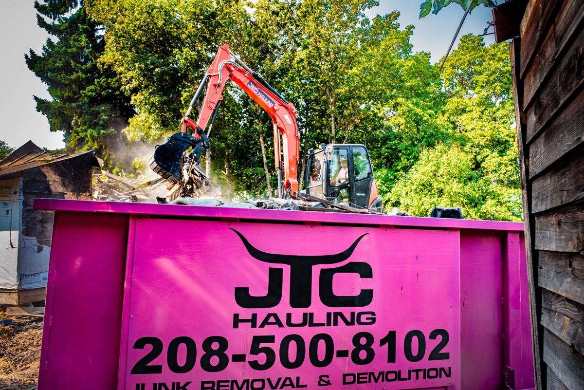 Loading a pink dumpster
